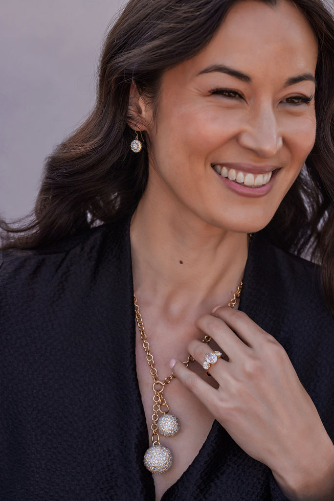 Close up of a woman wearing various jewelry from the Single Stone 2023 COUTURE collection.