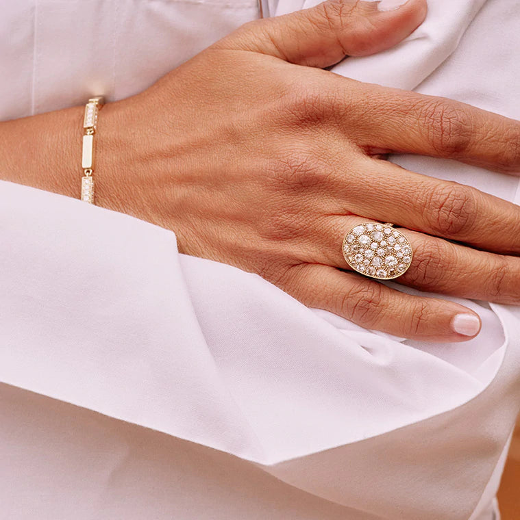Close up image of Syma's Single Stone oval cobblestone ring on her finger