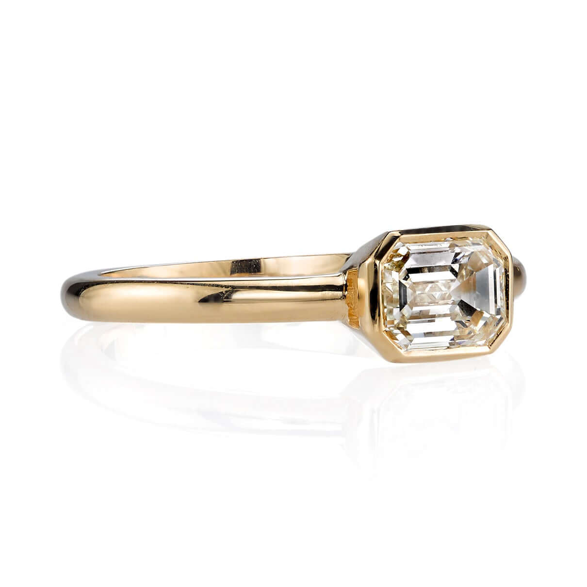 SINGLE STONE LEAH RING featuring 1.03ctw J/VVS1 HRD certified emerald cut diamond set in a handcrafted 18K yellow gold mounting.