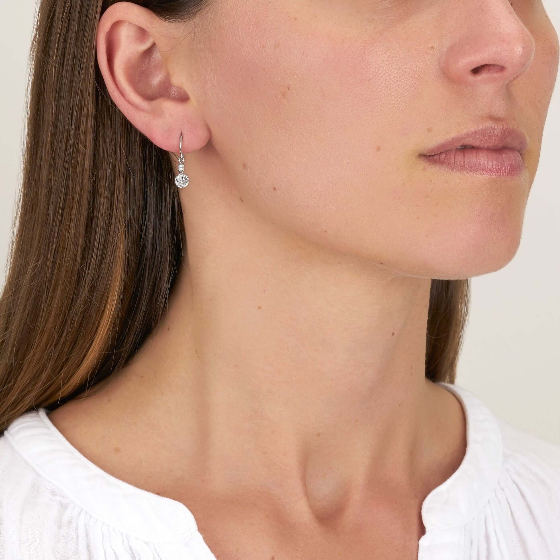 SINGLE STONE DUPRIE DROPS | Earrings featuring 1.21ctw G-H/VS2-SI1 antique old mine cut diamonds with 0.10ctw French cut accent diamonds bezel set in handcrafted platinum double drop earrings.