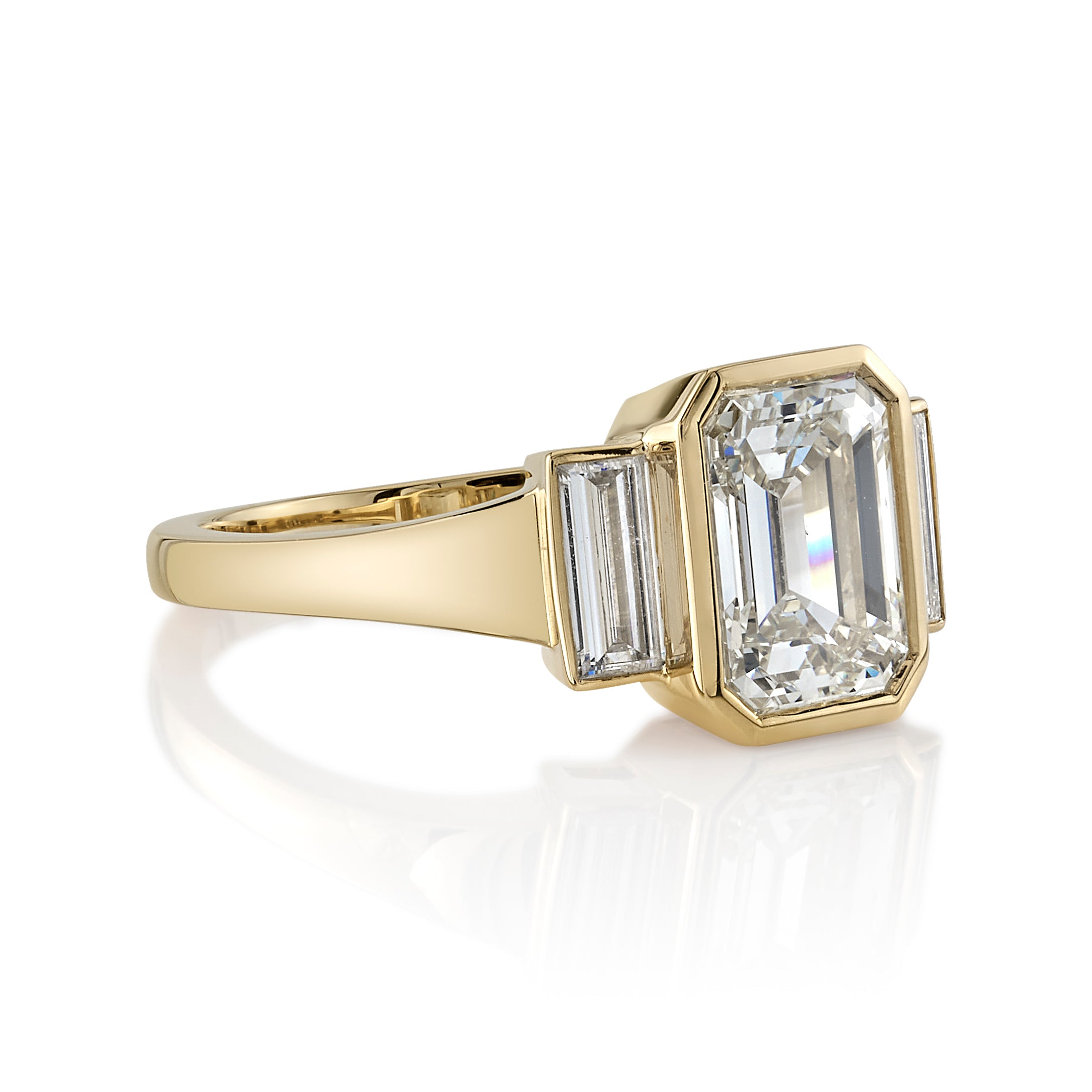 SINGLE STONE AMELIA RING featuring 2.00ct N/VVS2 GIA certified emerald cut diamond with 0.35ctw baguette cut accent diamonds bezel set in a handcrafted 18K yellow gold mounting.