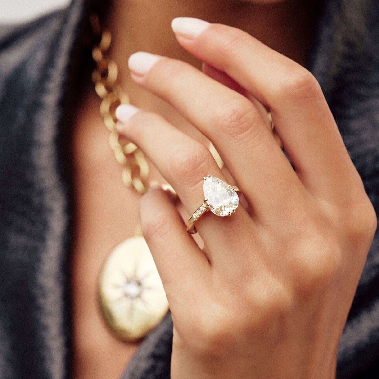 SINGLE STONE BAUER RING featuring 5.00ct L/VVS1 GIA certified antique pear shaped diamond with 0.11ctw old European cut accent diamonds set in a handcrafted 18K yellow gold mounting.