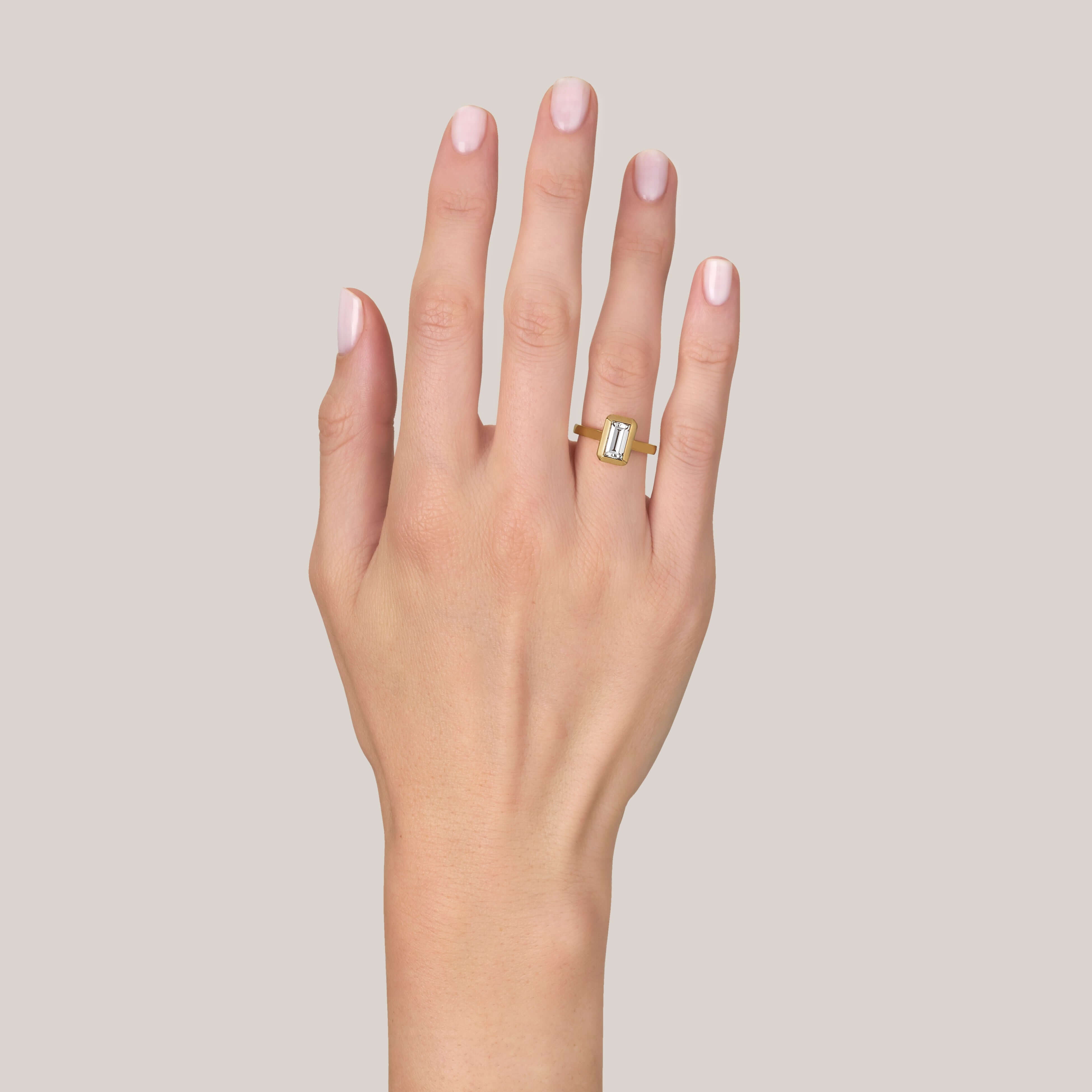 SINGLE STONE BEA RING featuring 1.27ct I/VS2 GIA certified rectangular step cut diamond set in a handcrafted 18K yellow gold mounting.