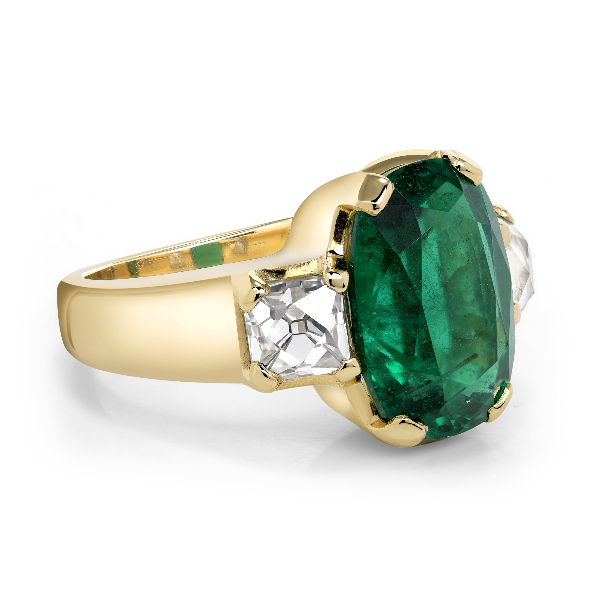 SINGLE STONE BROOKLYN RING featuring 6.08ct GIA certified Zambian cushion cut green emerald flanked by 1.61ctw GIA certified E-F/VS1 French cut diamonds prong set in a handcrafted 18K yellow gold mounting.