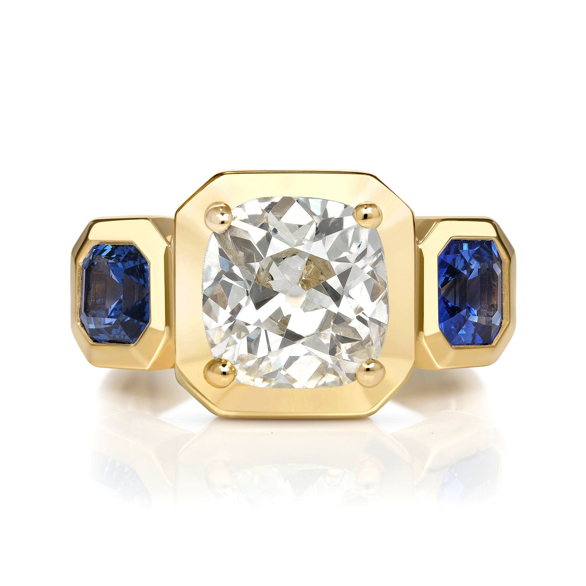 SINGLE STONE GLORIA RING featuring 2.86ct O-P/I2 GIA certified antique cushion cut diamond with 1.50ctw Asscher cut blue sapphires set in a handcrafted 18K yellow gold mounting.