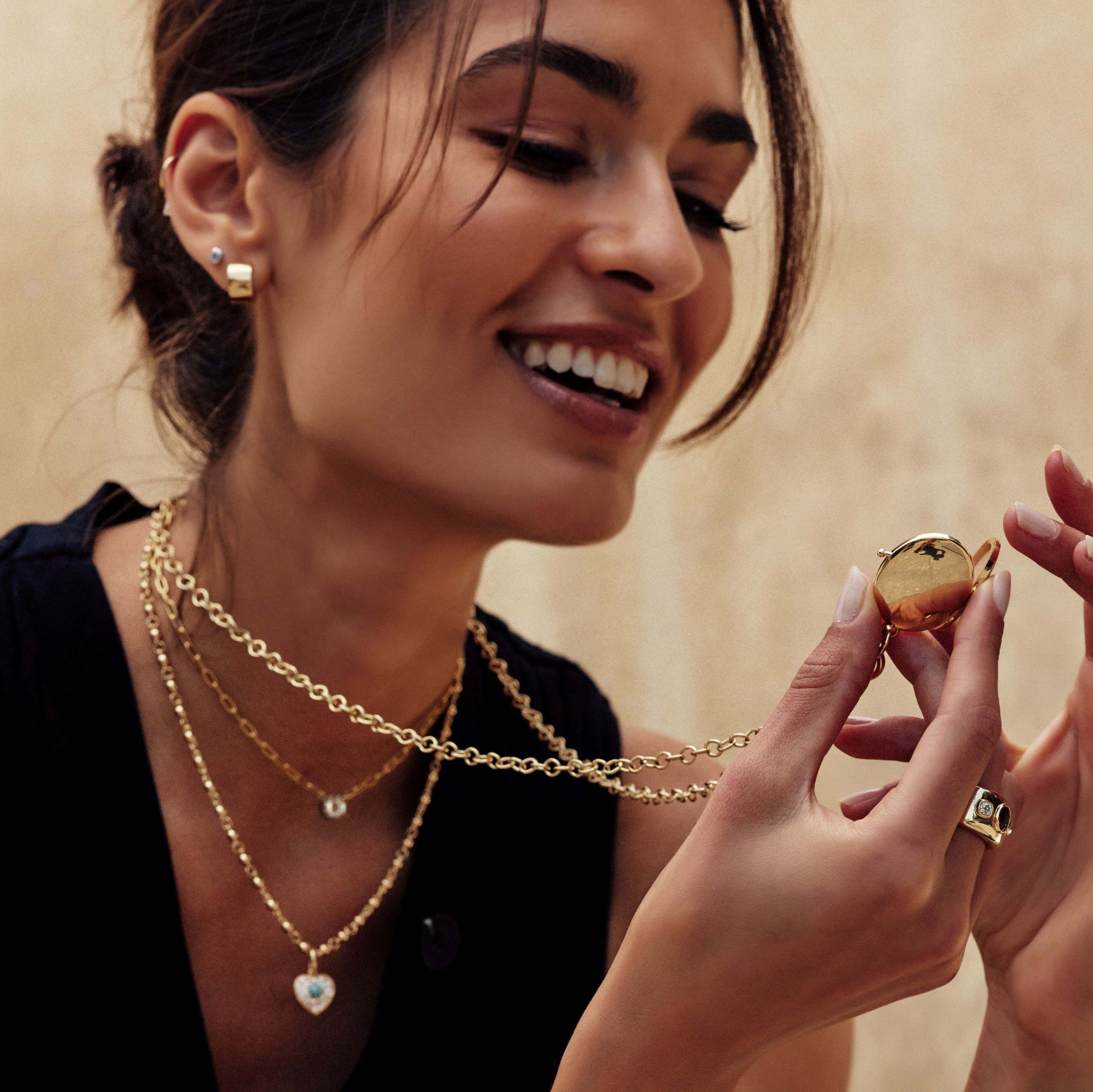 SINGLE STONE HARMONY LOCKET PENDANT featuring Handcrafted 18K yellow gold clasp and hinge locket - measures 34mm x 27mm. Locket can be monogrammed or engraved. Contact us for additional inquiries or customization. Price does not include chain.