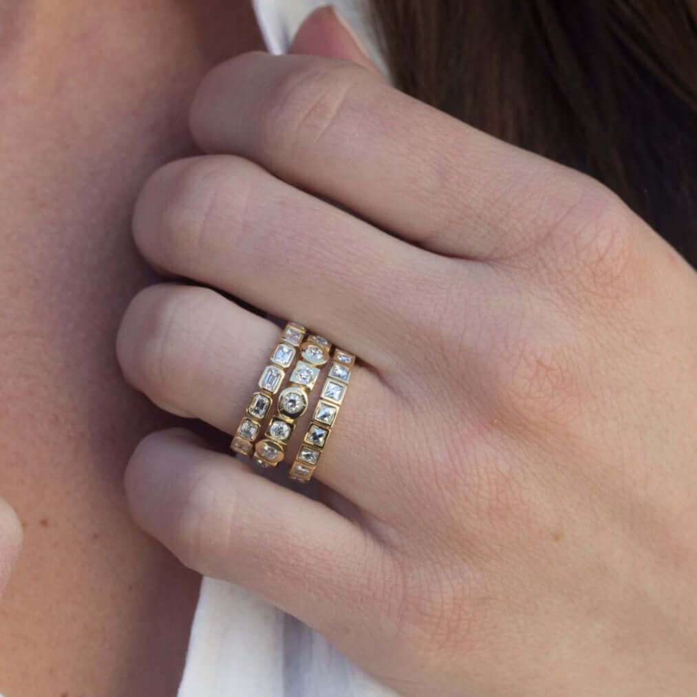 SINGLE STONE SIERRA BAND | Approximately 1.40ctw H-I/VS emerald cut diamonds bezel set in a handcrafted eternity band. Approximate band with 2.5mm. Please inquire for additional customization.