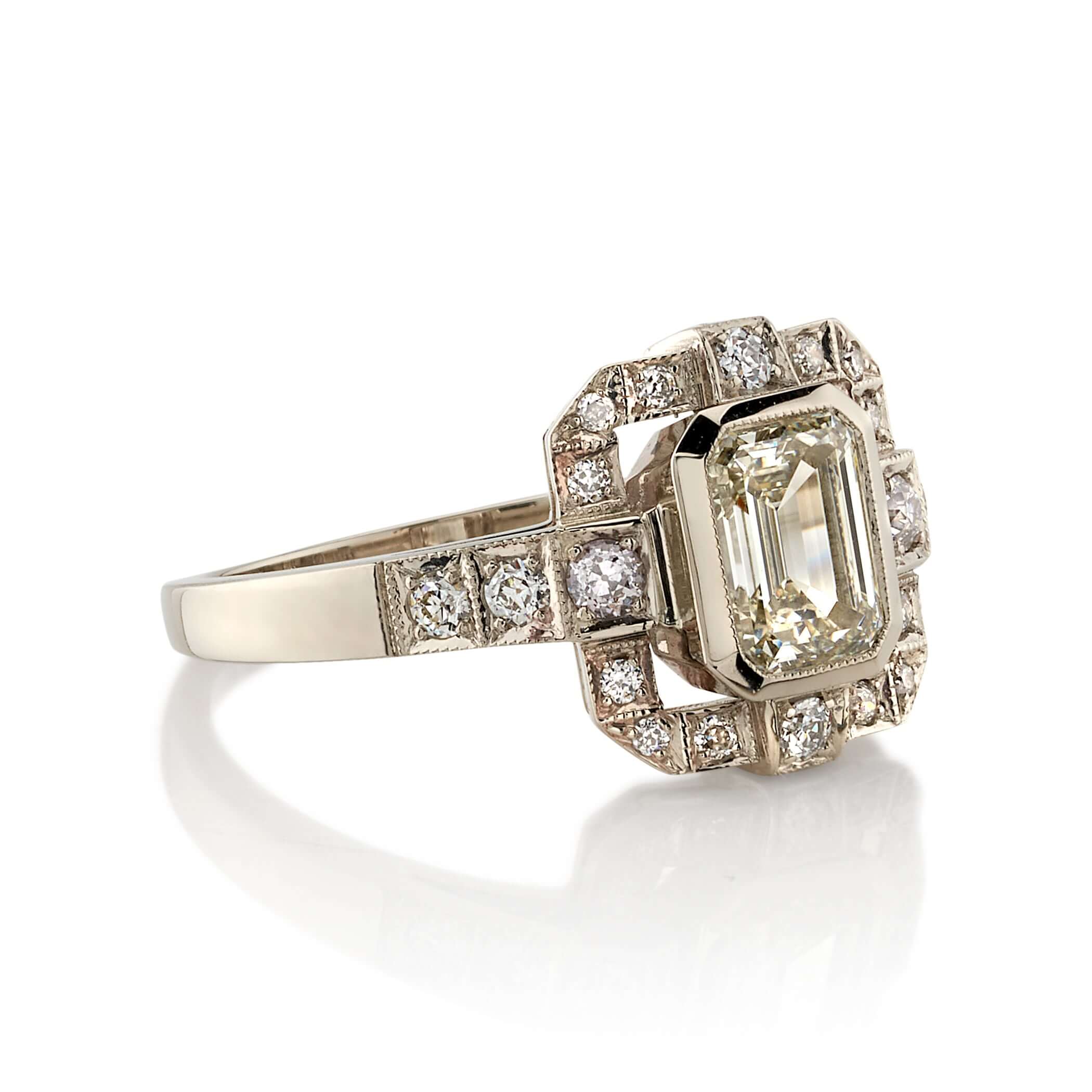 SINGLE STONE KATIE RING featuring 1.01ct N/VS2 GIA certified emerald cut diamond with 0.34ctw old European cut accent diamonds set in a handcrafted 18K champagne white gold mounting.