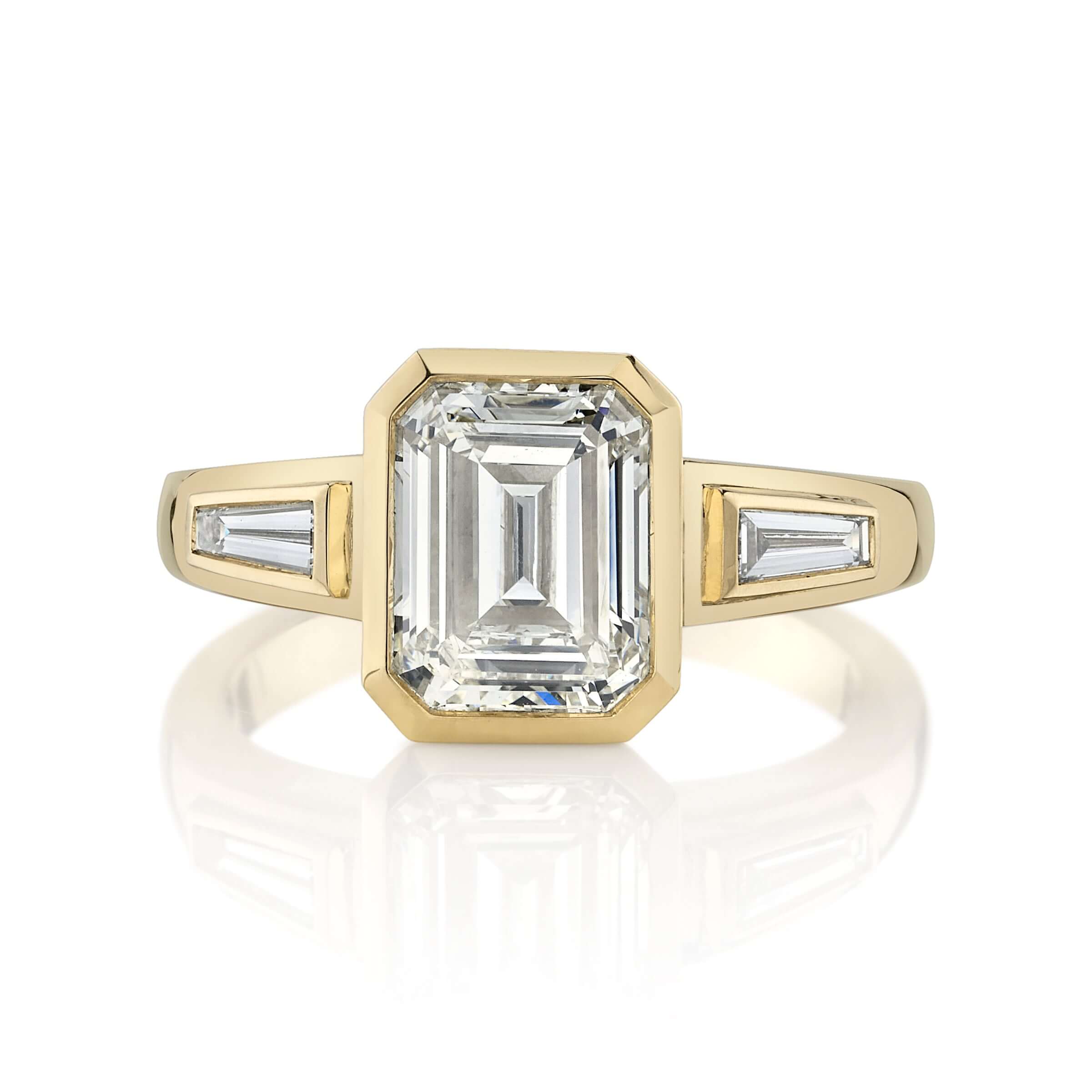 SINGLE STONE LAURIE RING featuring 2.00ct N/VS2 GIA certified emerald cut diamond with 0.24ctw baguette cut accent diamonds bezel set in a handcrafted 18K yellow gold mounting.