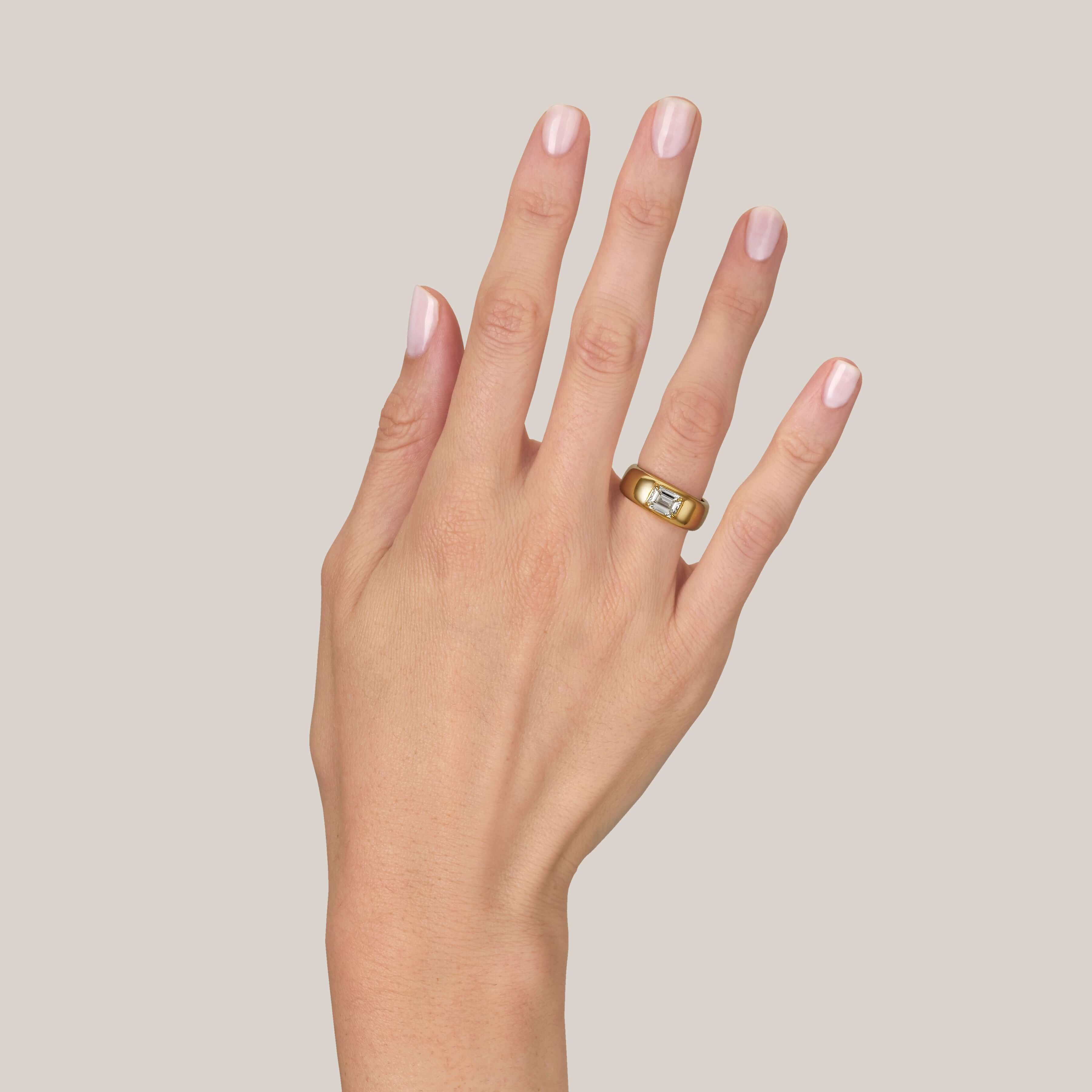 SINGLE STONE REMINGTON RING featuring 1.00ct U-V/SI1 GIA certified emerald cut diamond set in a handcrafted 18K yellow gold dome mounting.