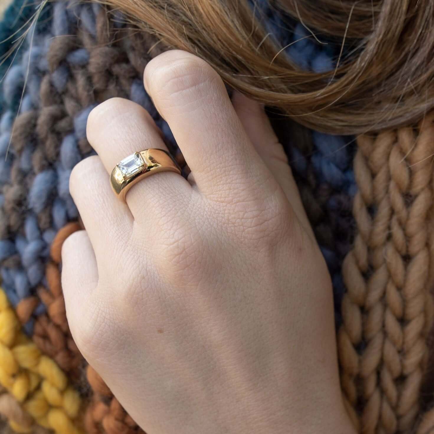 SINGLE STONE REMINGTON RING featuring 1.00ct U-V/SI1 GIA certified emerald cut diamond set in a handcrafted 18K yellow gold dome mounting.