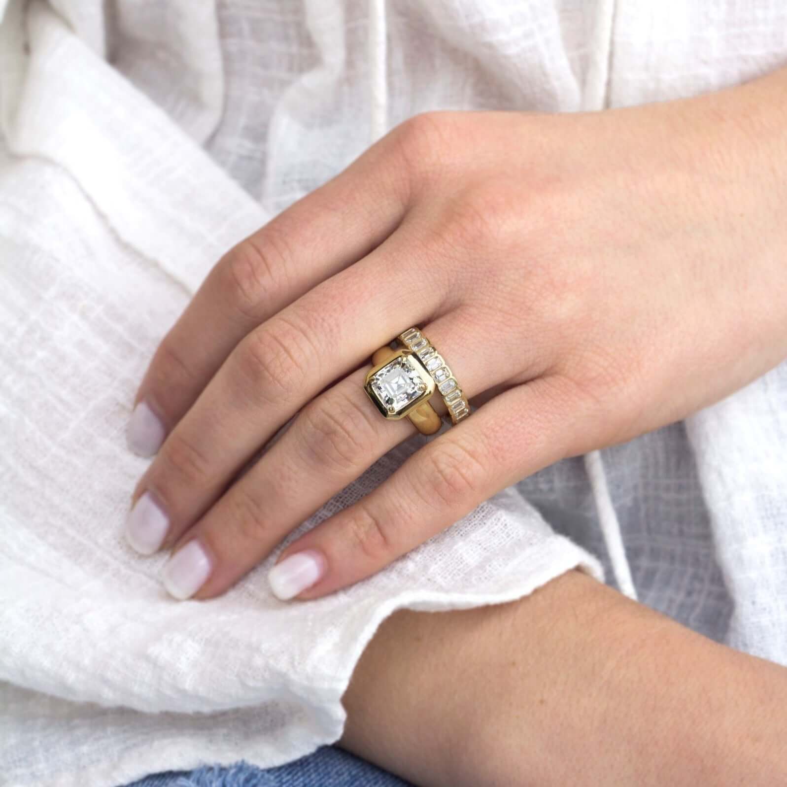 SINGLE STONE ATHENA BAND | Approximately 2.50ctw H-I/VS emerald cut diamonds bezel set in a handcrafted eternity band. Approximate band width 4mm. Please inquire for additional customization.