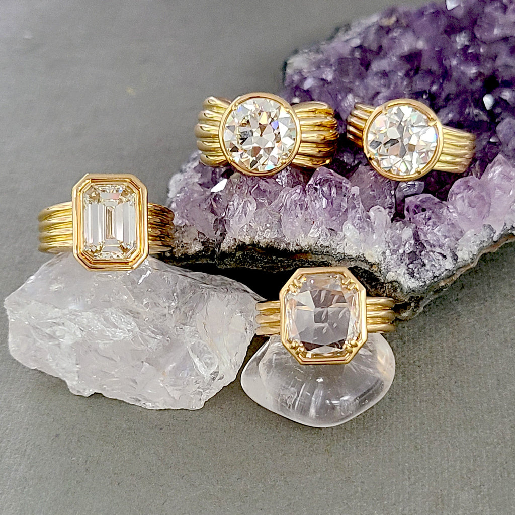 Bold gold diamond rings from Single Stone's Eleni collection featuring emerald cut, old European cut, and rose cut diamonds, perched on crystals