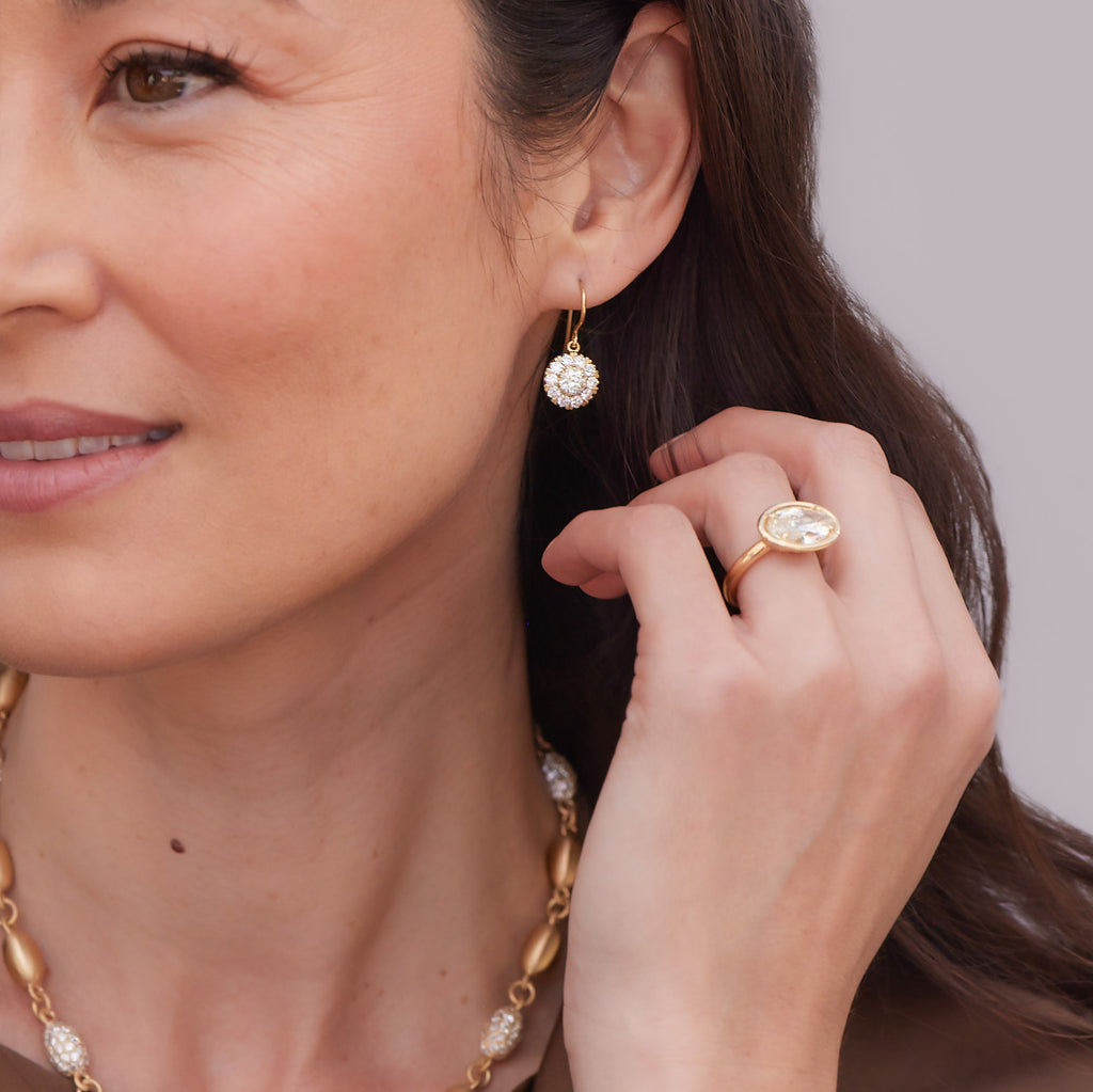 Woman wearing large diamond drop earrings from the Single Stone collection