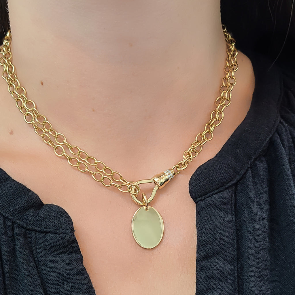 Single Stone's 20mm OVAL PENDANT pendant  featuring Handcrafted 20mm oval shaped pendant in 18K yellow gold. Price does not include chain.
