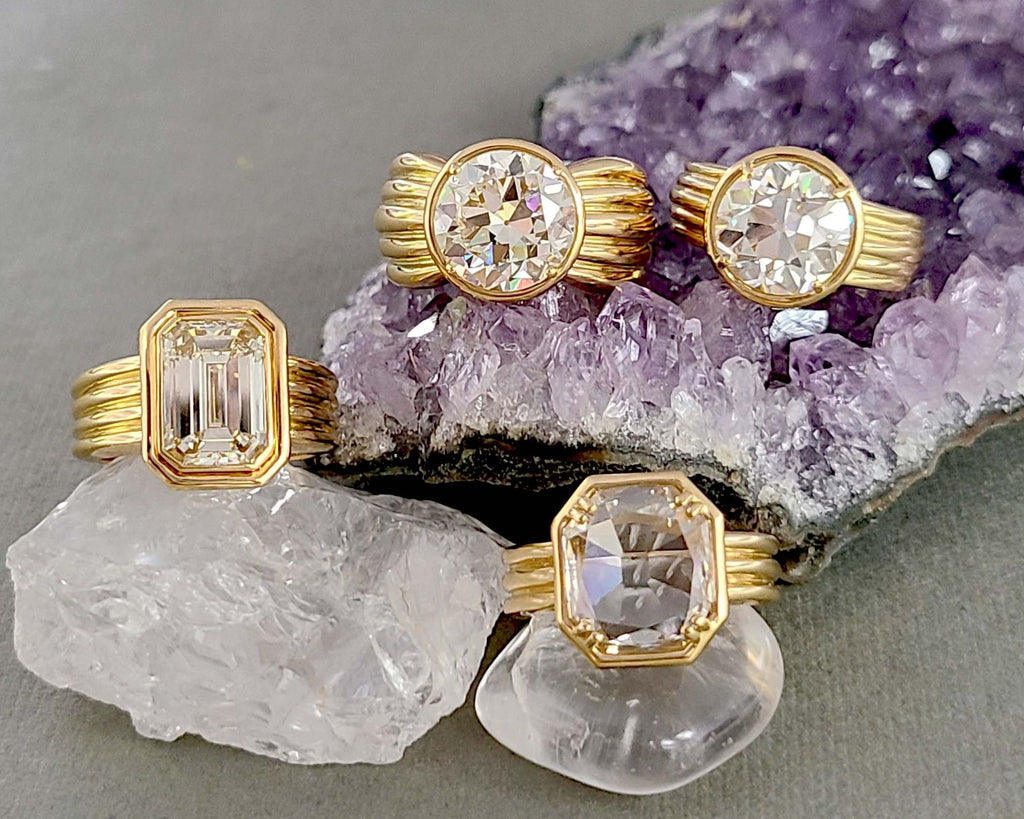  Bold gold diamond rings from Single Stone's Eleni collection featuring emerald cut, old European cut, and rose cut diamonds, perched on crystals