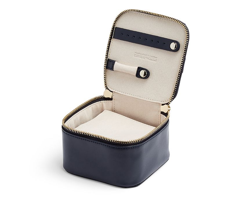 Single Stone's MARIA ZIP JEWELRY CUBE - NAVY  featuring Storage: 1 ring bar, 1 earring bar, 5 zip compartments LusterLoc™: Allows the fabric lining the inside of your jewellery cases to absorb the hostile gases known to cause tarnishing. Under typical storage conditions, it can prevent tarnishing for up to 35 years. 4.5&quot; L X 4.5&quot; W X 3&quot; H
