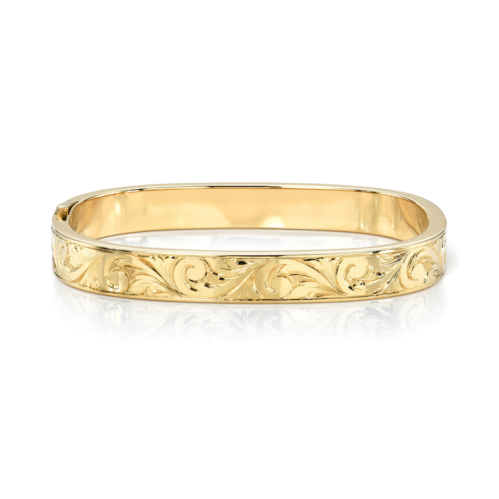 
Single Stone's Alex bangle, engraved  featuring Handcrafted, hand engraved 18K yellow gold bangle with snap closure.
