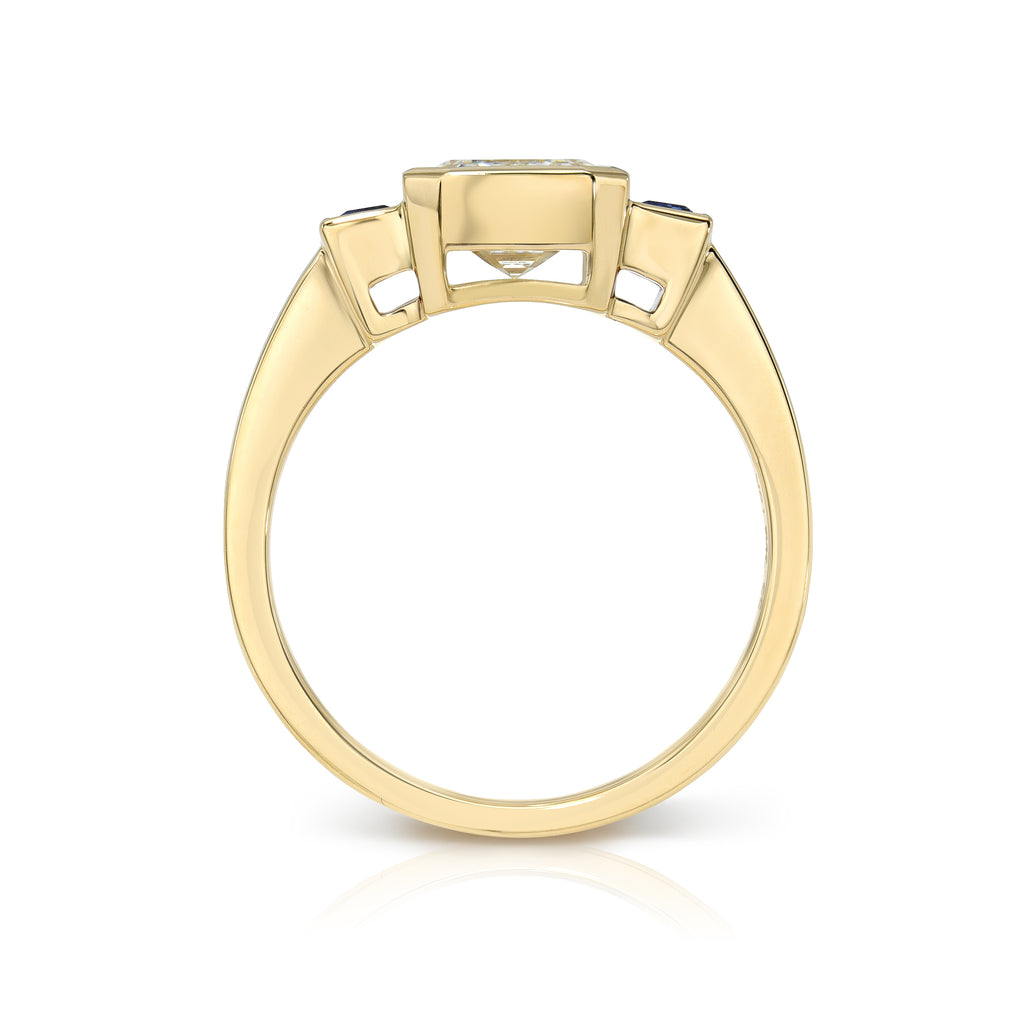Single Stone's AMELIA ring  featuring 2.01ct M/VS1 GIA certified emerald cut diamond with 0.51ctw baguette cut blue sapphires set in a handcrafted 18K yellow gold mounting.

