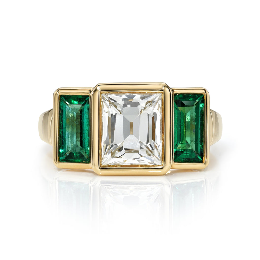 Single Stone's AMELIA ring  featuring 2.15ct L/VS2 GIA certified carré cut diamond with 0.84ctw baguette cut green emerald accents bezel set in a handcrafted 18K yellow gold mounting.
