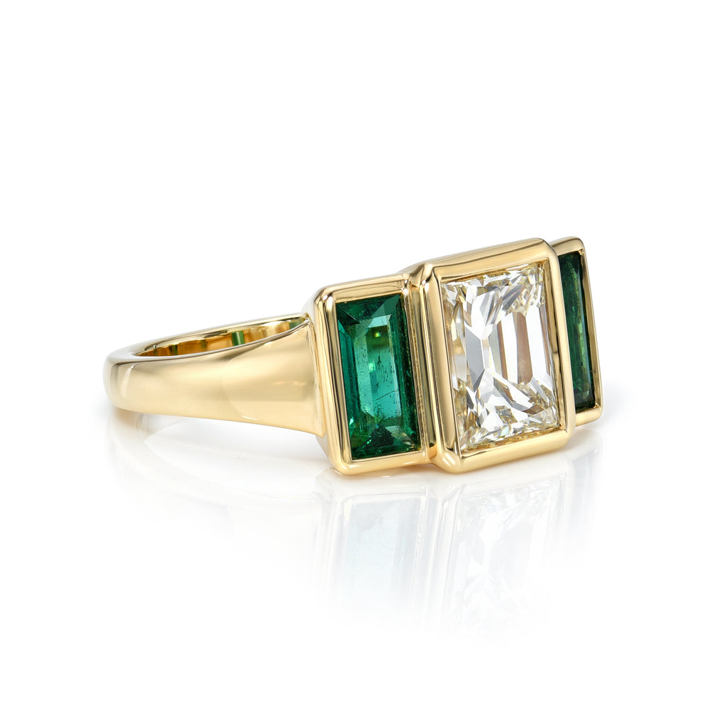 Single Stone's AMELIA ring  featuring 2.15ct L/VS2 GIA certified carré cut diamond with 0.84ctw baguette cut green emerald accents bezel set in a handcrafted 18K yellow gold mounting.

