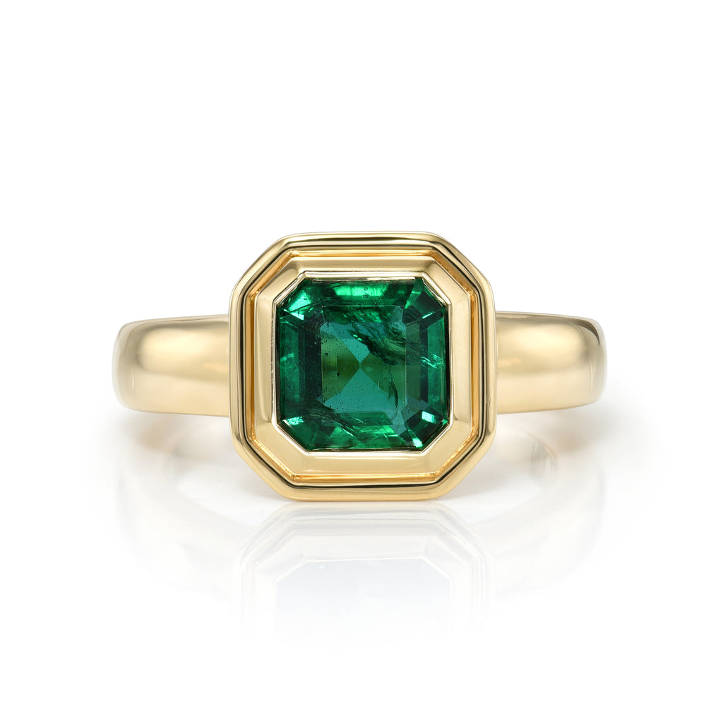 
Single Stone's Aria ring  featuring 1.90ct GIA certified Zambian Asscher cut natural green emerald bezel set in a handcrafted 18K yellow gold mounting.
