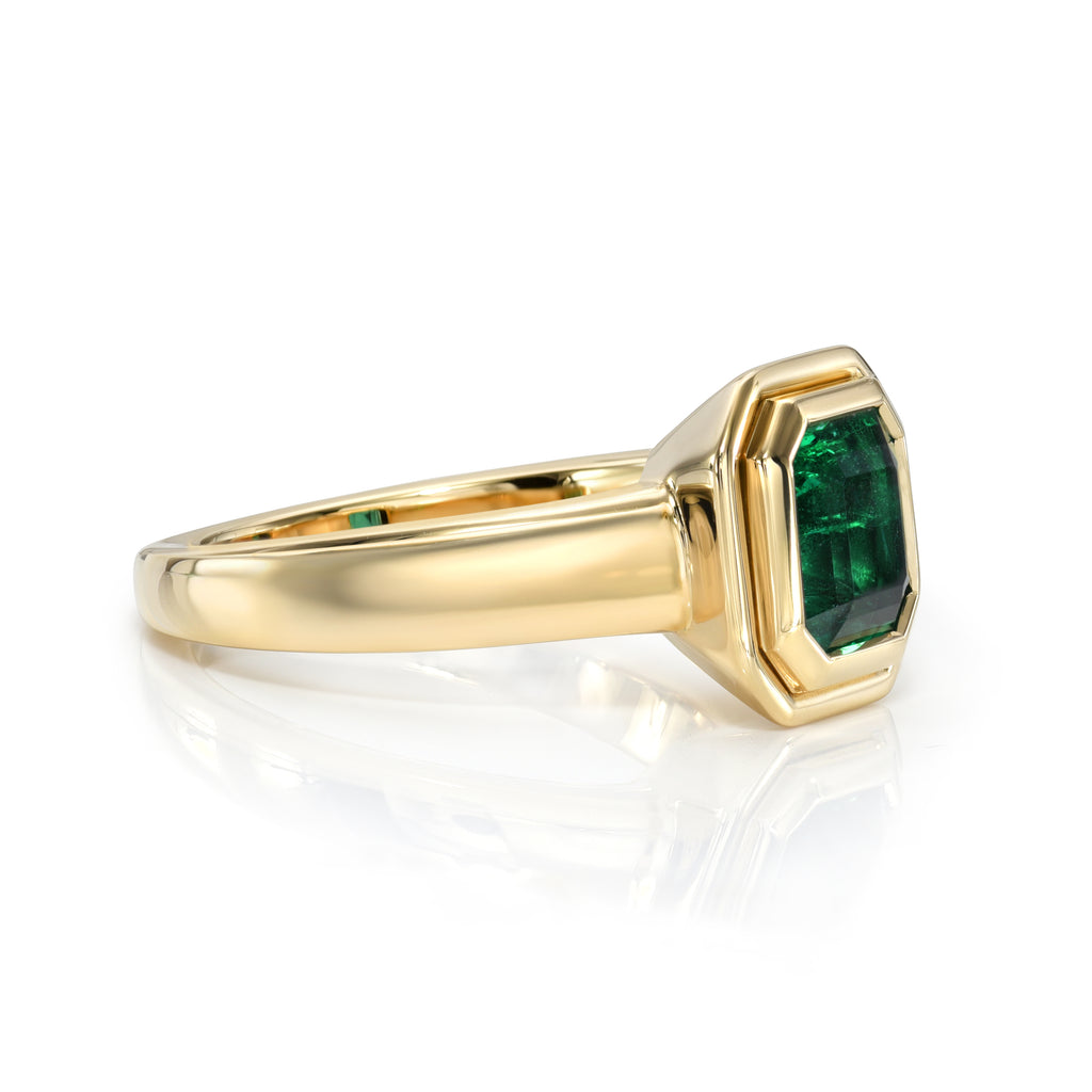 Single Stone's ARIA ring  featuring 1.90ct GIA certified Zambian Asscher cut natural green emerald bezel set in a handcrafted 18K yellow gold mounting.
