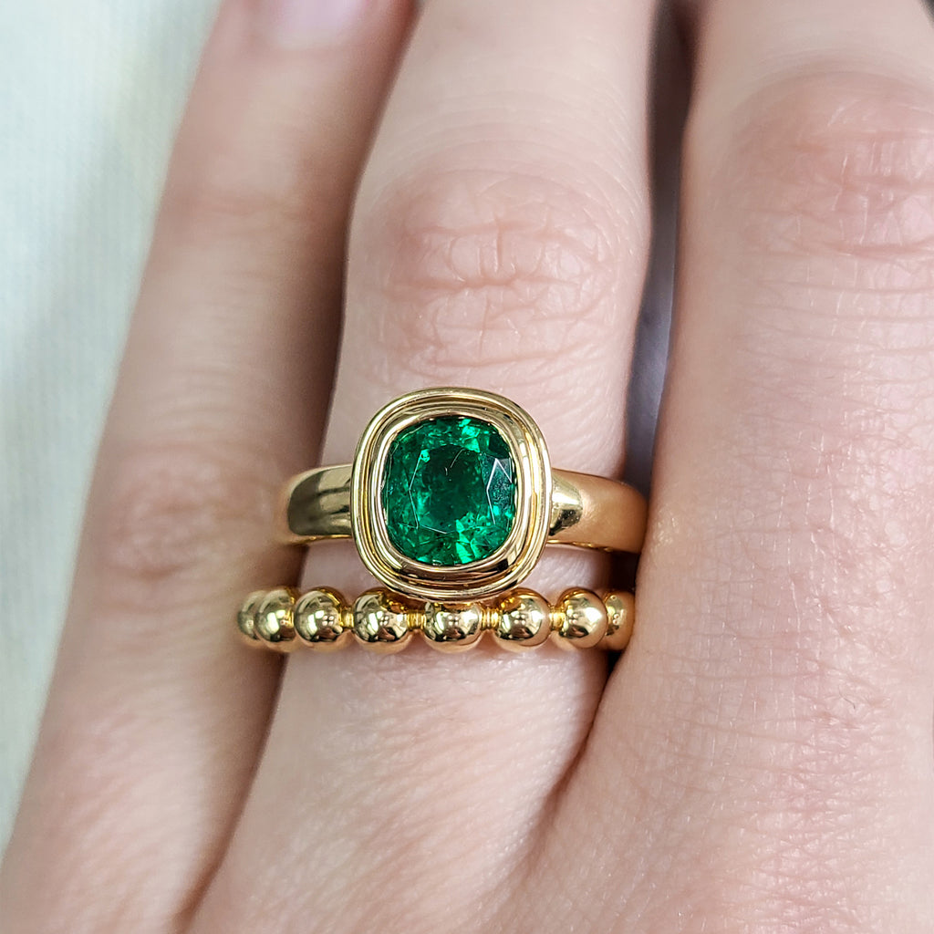 Single Stone's ARIA ring  featuring 1.64ct GIA certified Zambian antique cushion cut green emerald bezel set in a handcrafted 18K yellow gold mounting.
