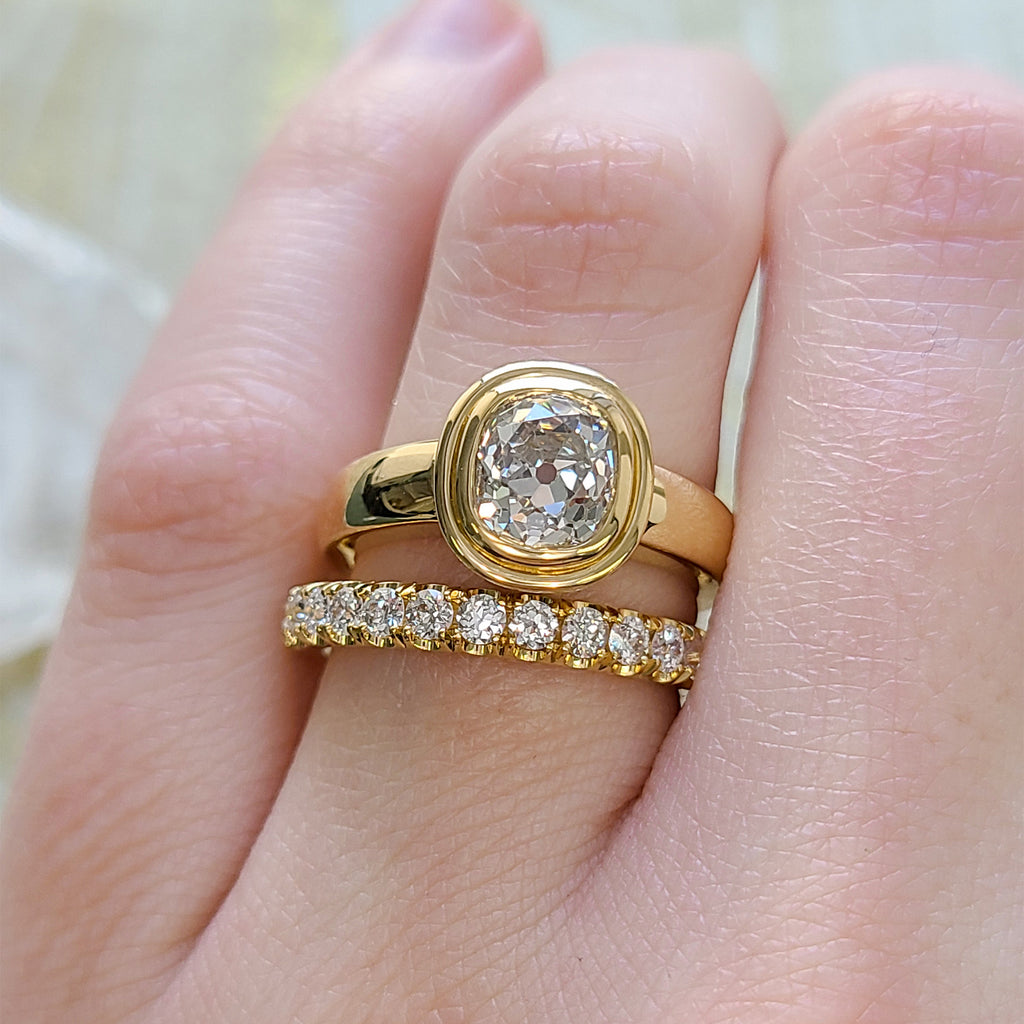 Single Stone's ARIA ring  featuring 1.74ct L/SI1 GIA certified antique cushion cut diamond bezel set in a handcrafted 18K yellow gold mounting.
