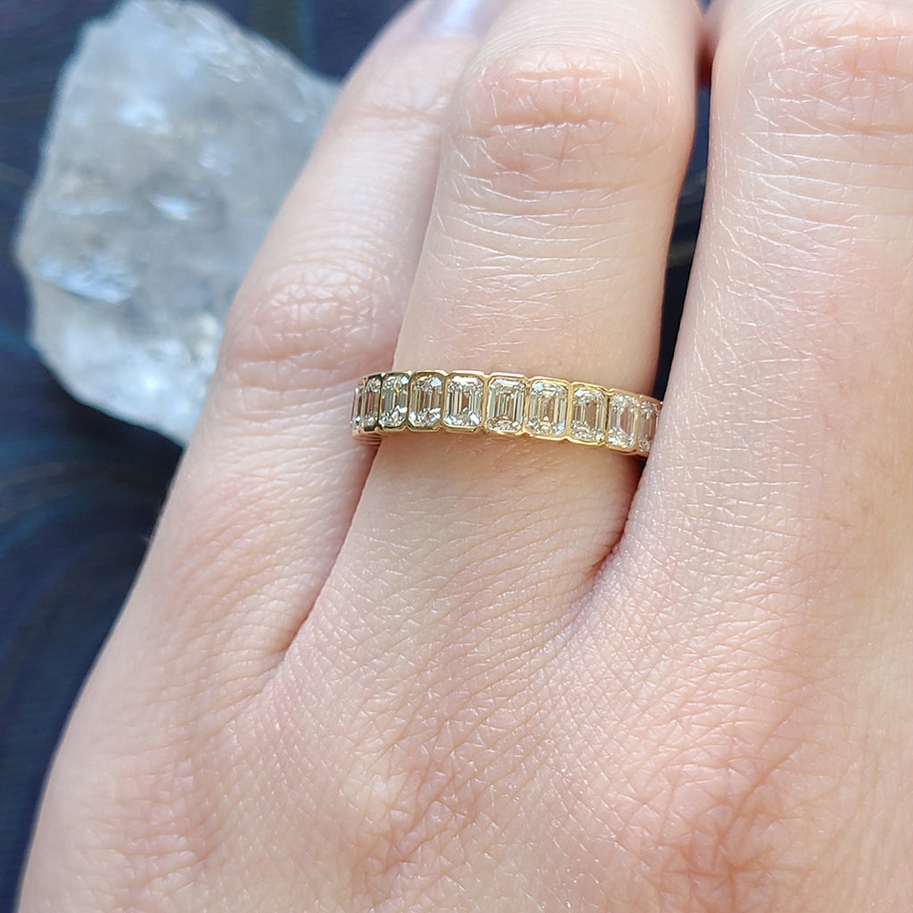 Single Stone's ATHENA band  featuring Approximately 2.50ctw H-I/VS emerald cut diamonds bezel set in a handcrafted eternity band. Approximate band width 4mm. Please inquire for additional customization.
