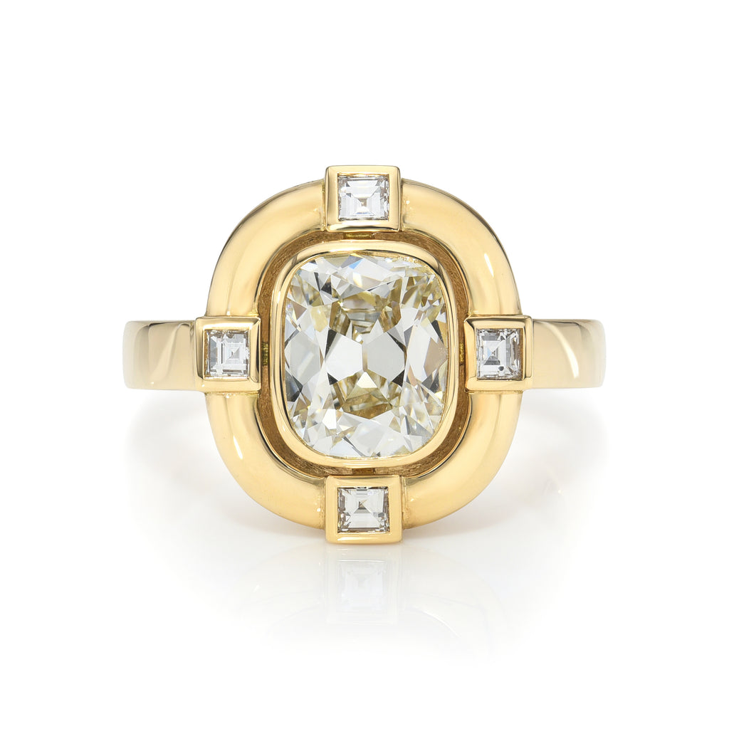 Single Stone's CARIS ring  featuring 1.77ct K/VVS2 GIA certified antique cushion cut diamond with 0.22ctw carré cut accent diamonds bezel set in a handcrafted 18K yellow gold mounting.
