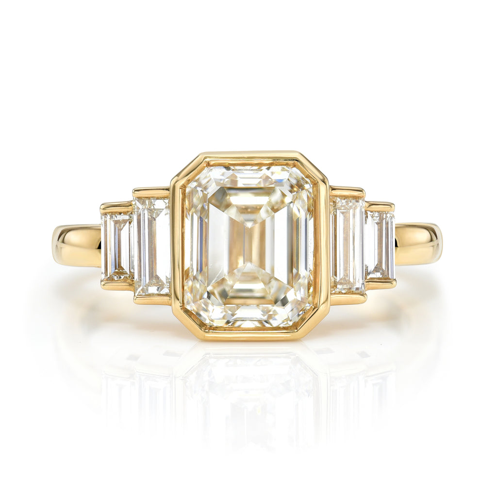
Single Stone's Caroline ring  featuring 2.00ct J/SI1 GIA certified emerald cut diamond with 0.40ctw baguette cut accent diamonds bezel set in a handcrafted 18K yellow gold mounting.

 
