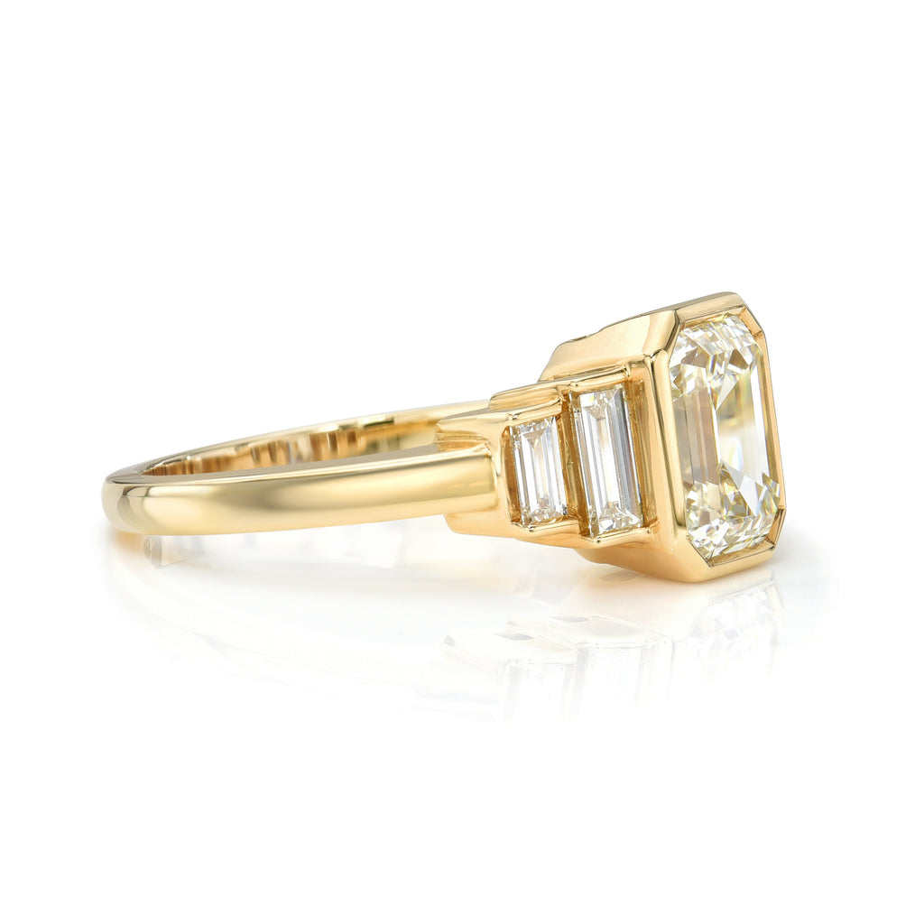 Single Stone's CAROLINE ring  featuring 2.00ct J/SI1 GIA certified emerald cut diamond with 0.40ctw baguette cut accent diamonds bezel set in a handcrafted 18K yellow gold mounting.  
