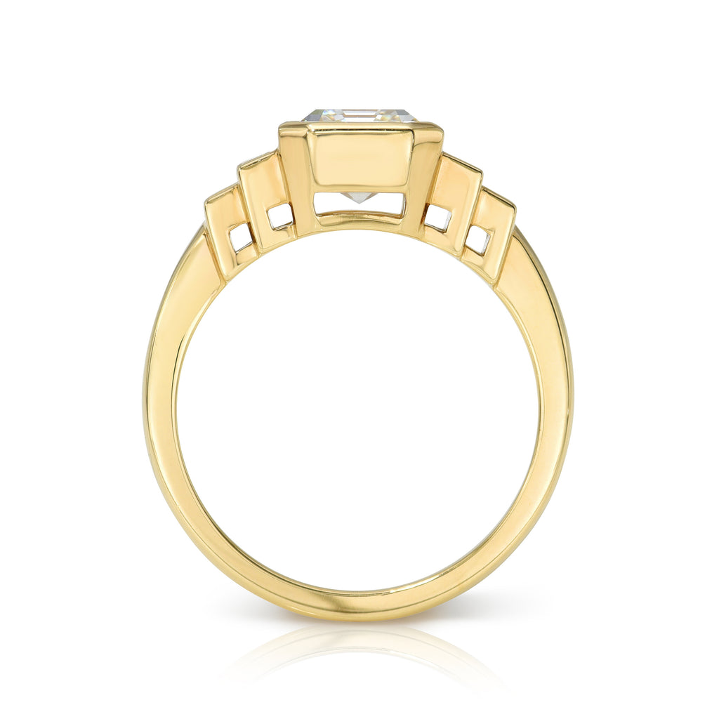 Single Stone's CAROLINE ring  featuring 2.00ct J/SI1 GIA certified emerald cut diamond with 0.40ctw baguette cut accent diamonds bezel set in a handcrafted 18K yellow gold mounting.  
