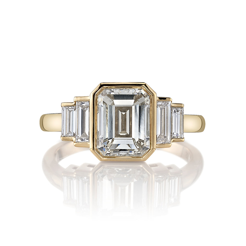 
Single Stone's Caroline ring  featuring 2.08ct K/VVS1 GIA certified emerald cut diamond with 0.53ctw baguette cut accent diamonds bezel set in a handcrafted 18K yellow gold mounting.
 
