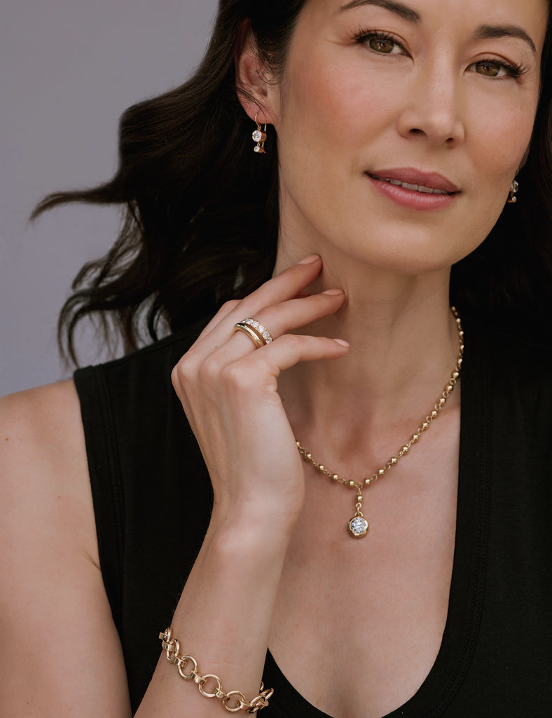 Close up of a woman wearing various jewelry from the Single Stone 2023 COUTURE collection.