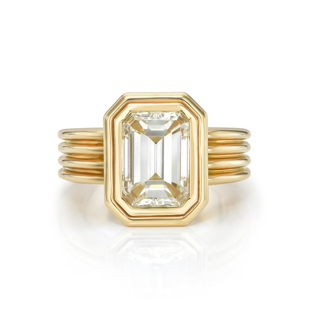 
Single Stone's Eleni ring  featuring 3.03ct N/VS2 GIA certified emerald cut diamond bezel set in a handcrafted 18K yellow gold mounting.
