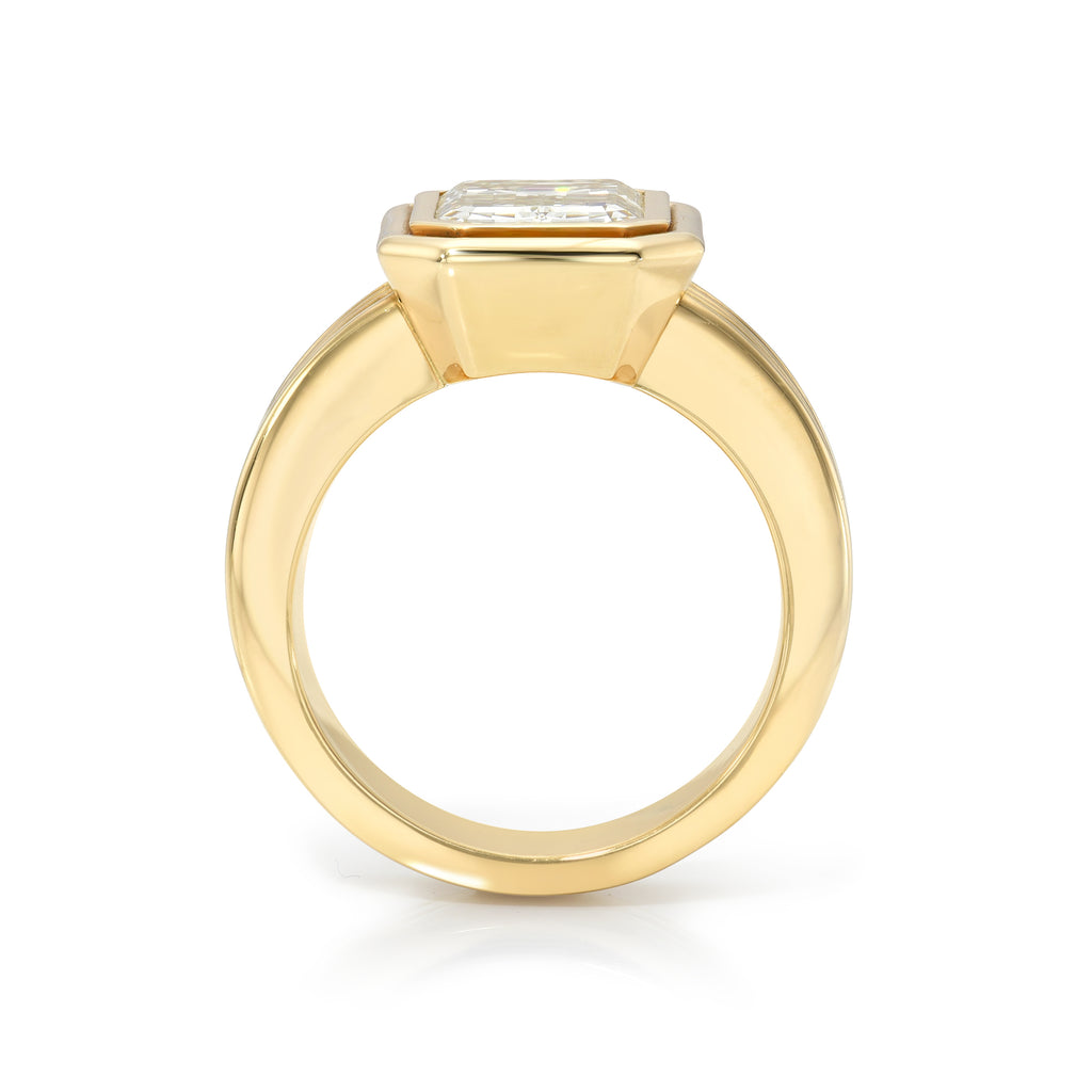 Single Stone's ELENI ring  featuring 3.03ct N/VS2 GIA certified emerald cut diamond bezel set in a handcrafted 18K yellow gold mounting.

