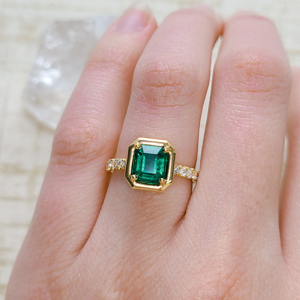 Single Stone's ELLA ring  featuring 1.69ct GIA certified Zambian Asscher cut green emerald with 0.40ctw old European cut accent diamonds prong set in a handcrafted 18K yellow gold mounting.
