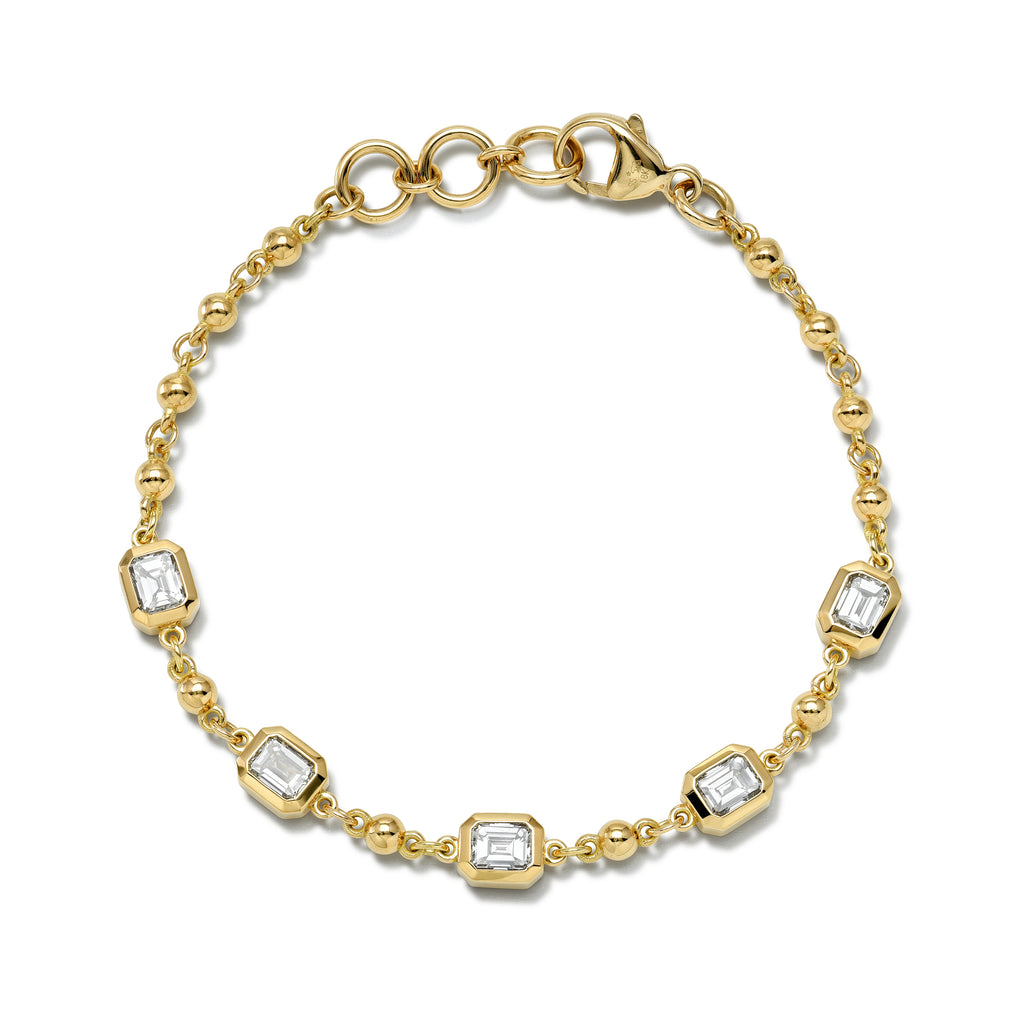 Single Stone's FIVE STONE SERALINA BRACELET  featuring Approximately 2.50ctw J-K/VS bezel set emerald cut diamonds on a handcrafted 18K yellow gold rosary bracelet. Prices may vary according to diamond weight.
