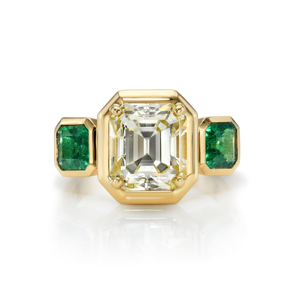 Single Stone's GLORIA ring  featuring 3.50ct W-X/VS1 GIA certified Asscher cut diamond with 1.03ctw Asscher cut green emeralds bezel set in a handcrafted 18K yellow gold mounting.
