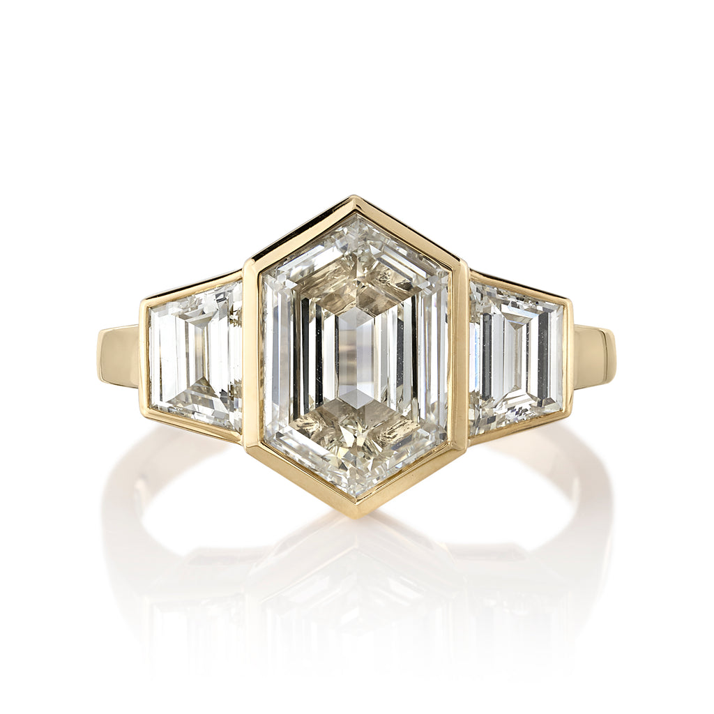 Single Stone's KATYA ring  featuring 2.00ct M/VVS2 GIA certified hexagonal step cut diamond with 0.77ctw trapezoid cut accent diamonds bezel set in a handcrafted 18K yellow gold mounting.  
