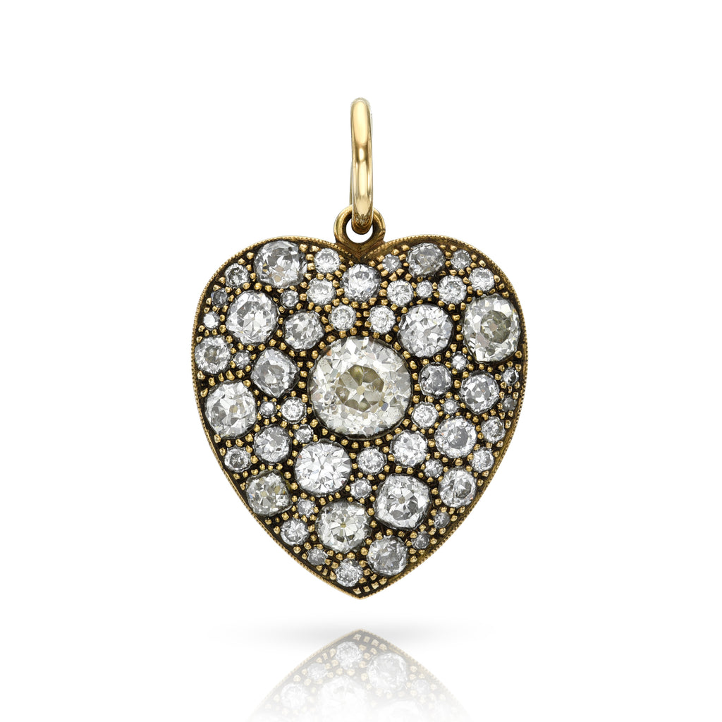 
Single Stone's Large cobblestone heart pendant  featuring 1.46ct O-P/I1 GIA certified old European cut diamond surrounded by 3.89ctw varying old cut and round brilliant cut diamonds set in a handcrafted, oxidized 18K yellow gold heart-shaped pendant.
