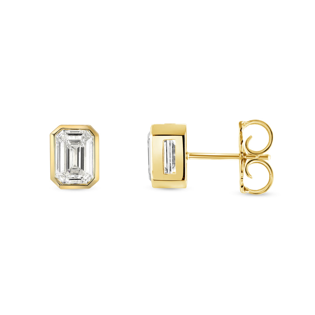 
Single Stone's Leah studs earrings  featuring 3.01ctw K/SI1-VS2 GIA certified emerald cut diamonds bezel set in handcrafted 18K yellow gold stud earrings.
