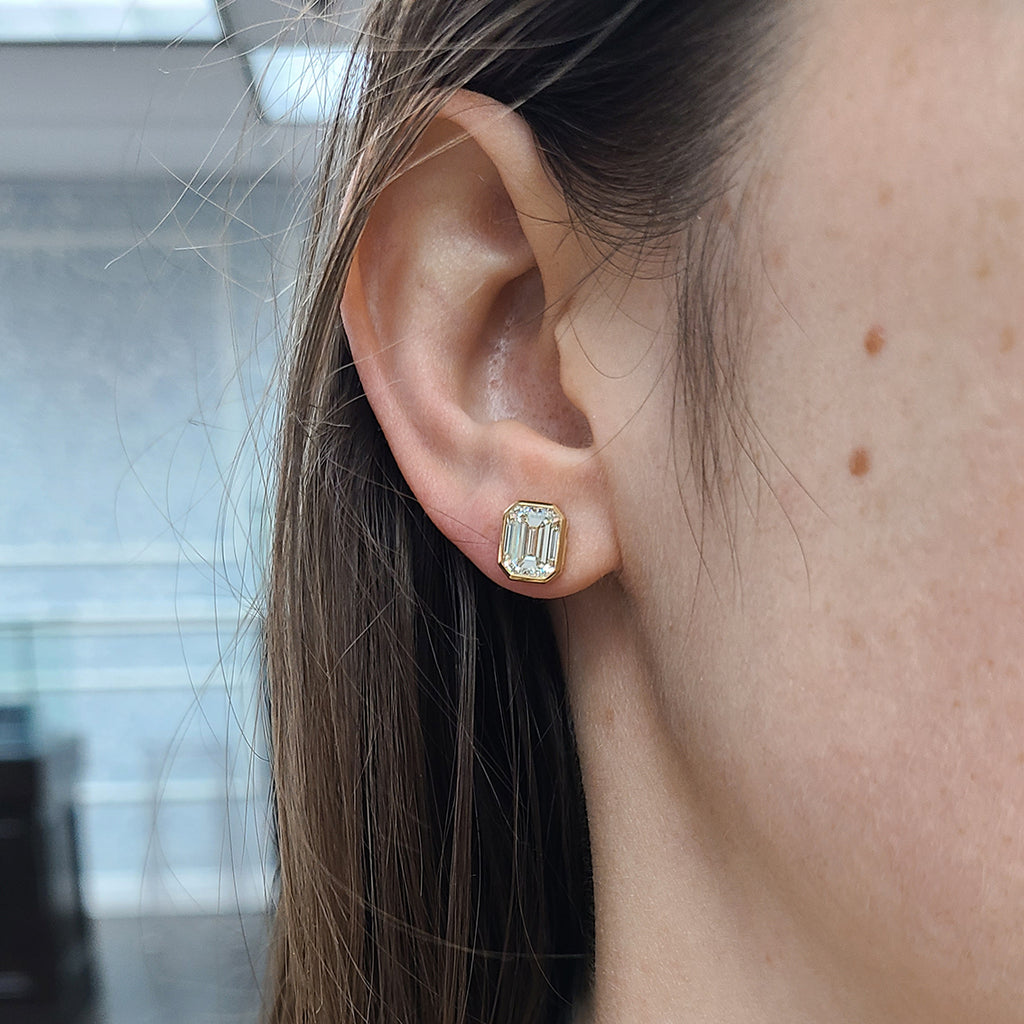 Single Stone's LEAH STUDS  featuring 4.02ctw O-P/VVS1 GIA certified emerald cut diamonds bezel set in handcrafted 18K yellow gold stud earrings.
