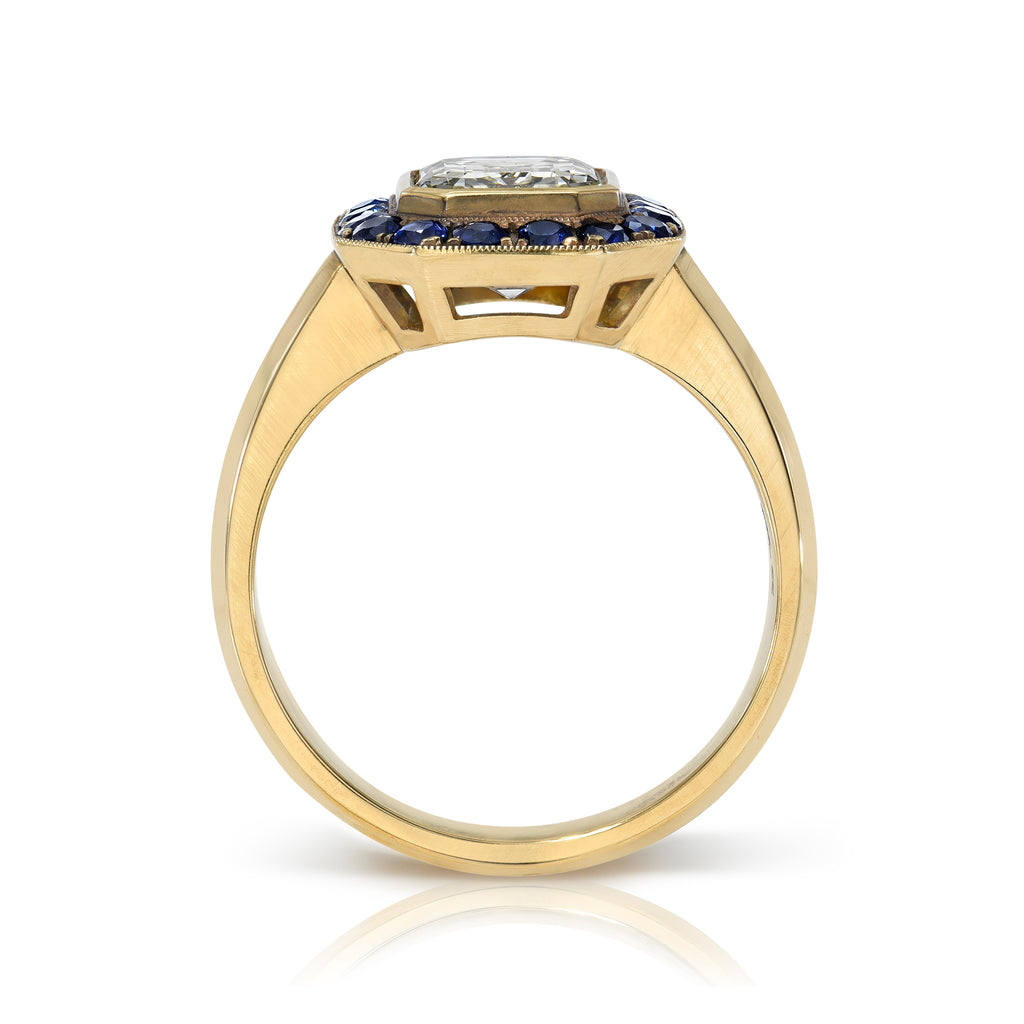Single Stone's MARIA PAVÉ ring  featuring 2.00ct M/VS1 GIA certified bezel set emerald cut diamond with 0.55ctw round cut blue sapphire accent gemstones pavé set in a handcrafted, lightly oxidized 18K yellow gold mounting.
