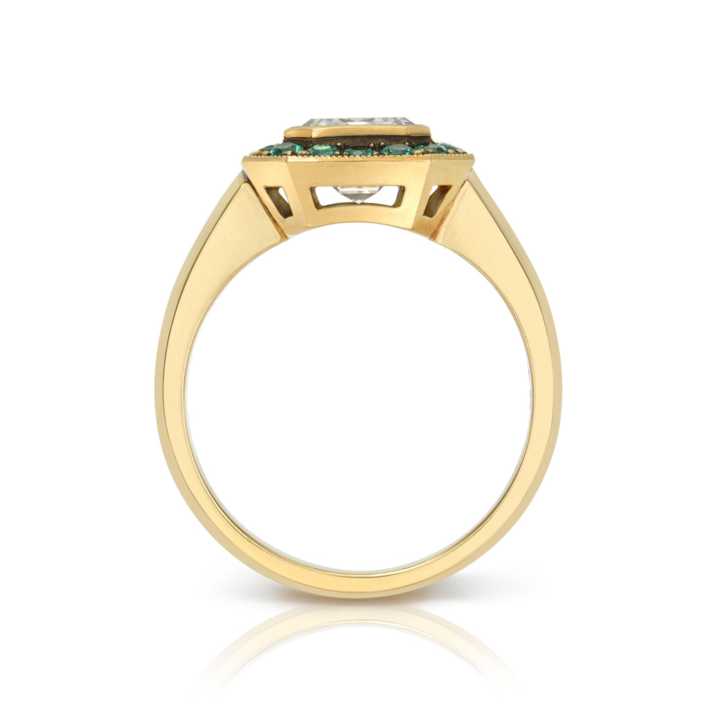 Single Stone's MARIA PAVÉ ring  featuring 2.02ct M/VVS1 GIA certified bezel set emerald cut diamond with 0.30ctw round cut green emerald accent gemstones pavé set in a handcrafted, lightly oxidized 18K yellow gold mounting.
