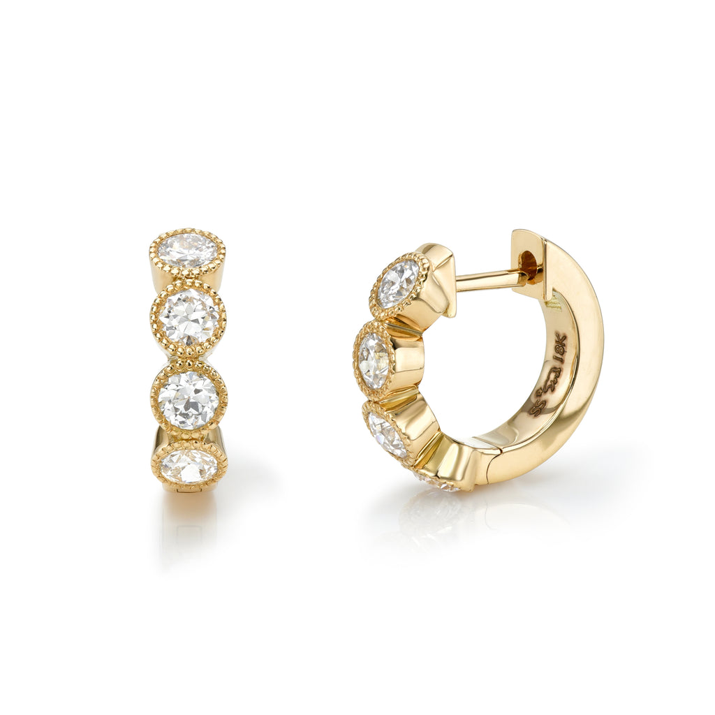 
Single Stone's Medium gabby huggies earrings  featuring Approximately 0.65-0.70ctw old European cut diamonds bezel set in handcrafted 18K yellow gold huggie earrings.
