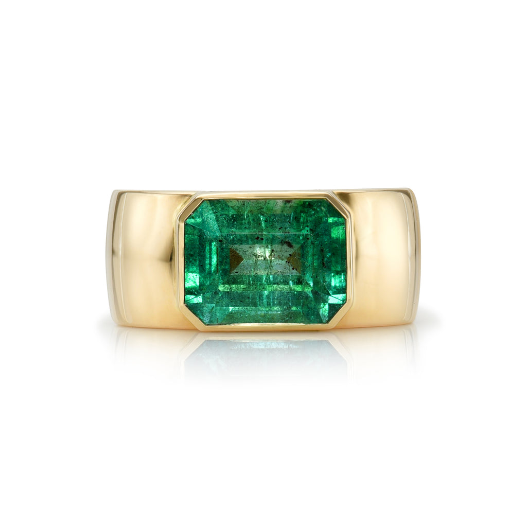 
Single Stone's Misha ring  featuring 3.15ct GIA certified emerald cut green emerald bezel set in a handcrafted 18K yellow gold wide cigar band
