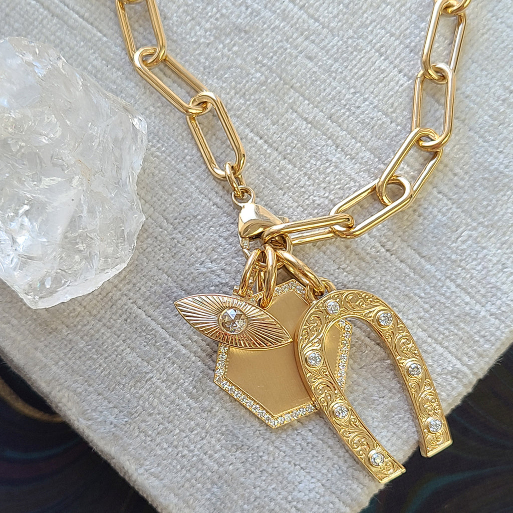 Single Stone's SMALL NAYA pendant  featuring Approximately 0.15ct G-H/VS rose cut diamond bezel set in a handcrafted 18K yellow gold semi-oval shaped pendant.
